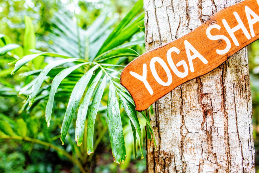 hanging brown and white yoga signboard