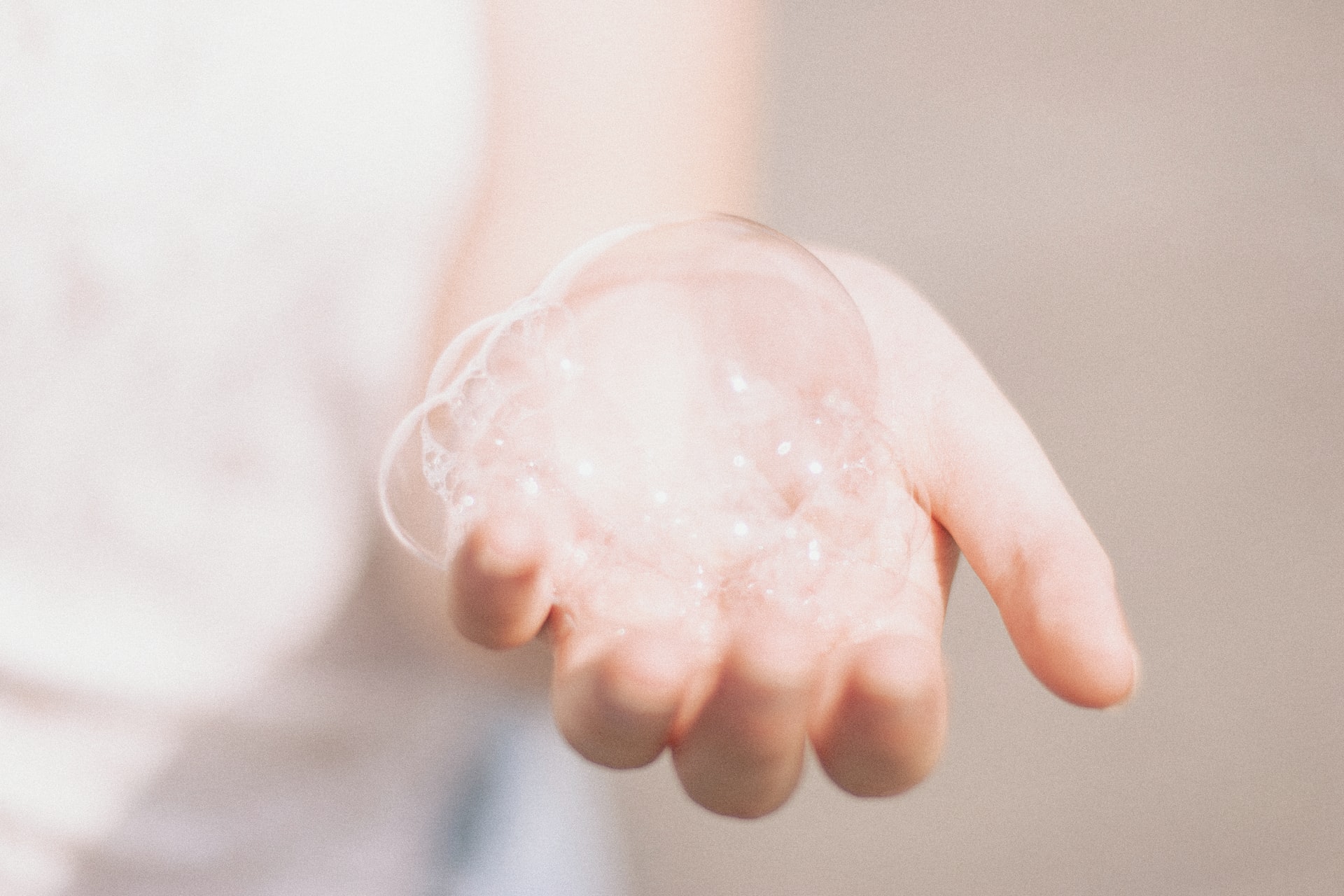 person holding bubbles on one hand