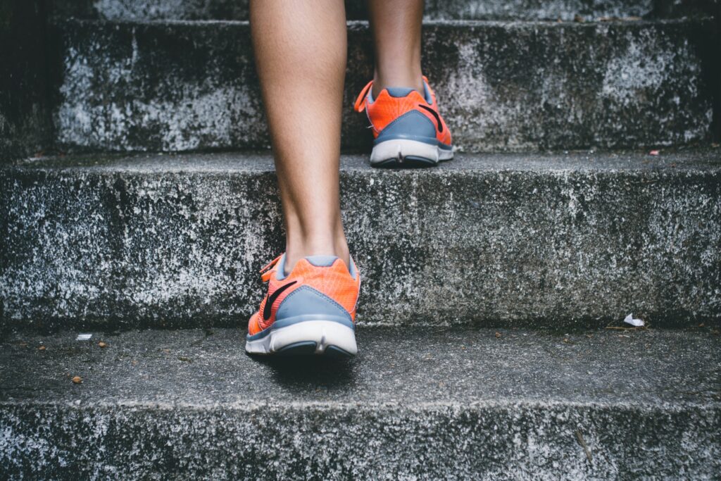 person wearing orange and gray shoes